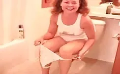 Playing with her pussy while pooping