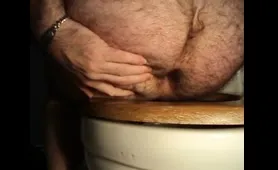 Man dumps a huge red load in the toilet