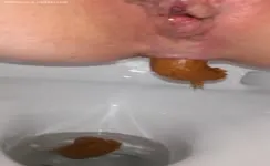Shaved babe shitting