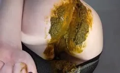 Dark haired babe smears shit on big ass