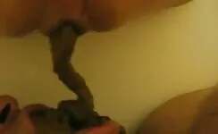 Closeup of sexy lady pooping in her hubby's mouth 