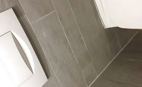 Sexy brunette milf swallows cum in public bathroom