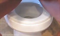 Shaved teen shitting over toilet
