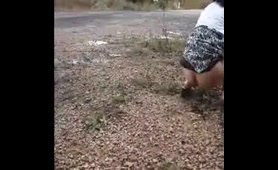 Woman Pees on the Side of the Road