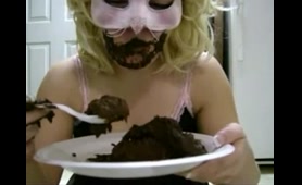 Masked woman eats Shit from a plate