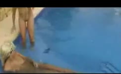 Two girls poop together in a pool