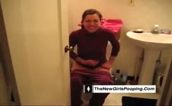 Dark haired babe pooping over toilet